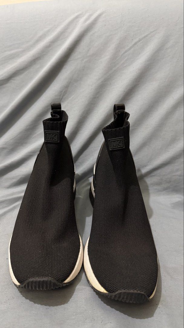 Michael Kors Black Sock Sneakers (Category: Sneakers) located in Cavite. Submitted by maxs.bl (Listing ID 1458353825, Image 1). Description: - Brand: Michael Kors - Style: Sock Sneakers - Color: Black - Design: Slip-on with comfortable knit upper - Details: MK logo on front, "Michael Kors" on back heel - Sole: White with black trim - Occasion: Perfect for casual outings.