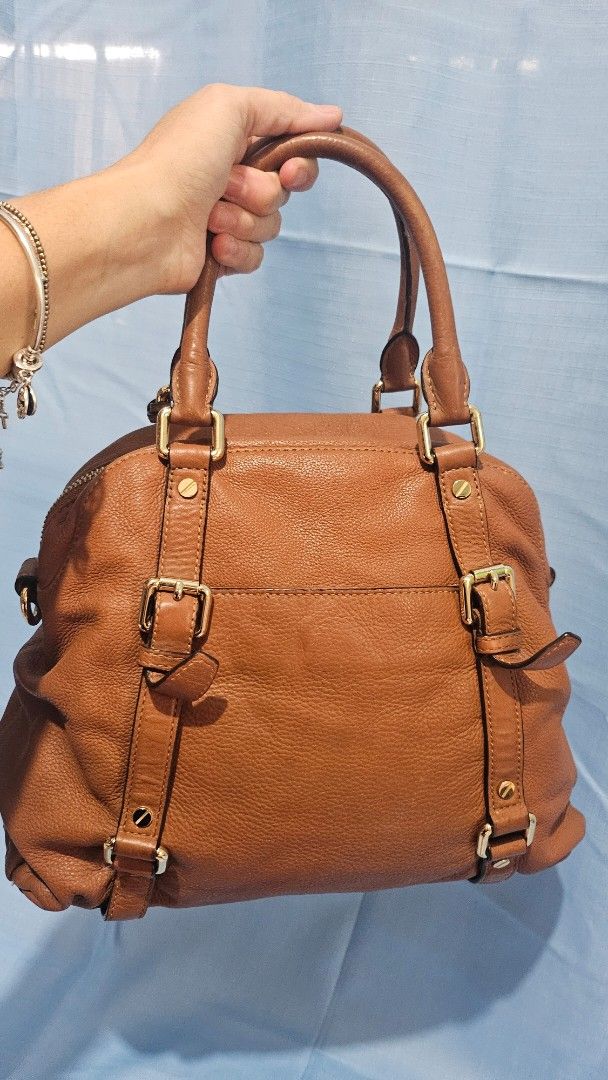Michael Kors Brown Leather Satchel Bag with Strap (Category: Luxury Bags & Wallets) located in Quezon City. Submitted by maryann17 (Listing ID 1458395556, Image 3). Description: decluttering personal item 💯% original office bag large capacity - Genuine brown leather Michael Kors satchel bag - Versatile with top handles and a detachable shoulder strap - Elegant gold hardware details - Functional interior with multiple pockets - Secure zipper clos