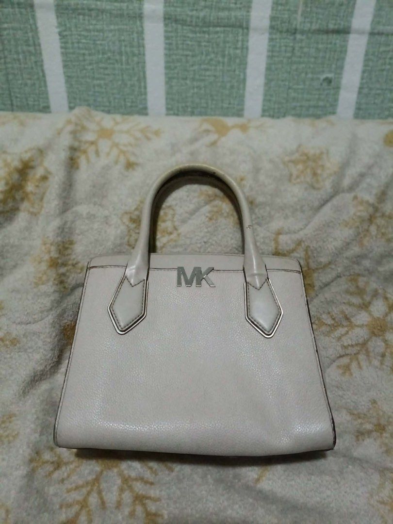 Auth Michael Kors Handbag (Category: Luxury Bags & Wallets) located in Manila. Submitted by handpickedbycox (Listing ID 1458415542, Image 1). Description: 📌Authentic Michael Kors handbag - Color: Light beige/off-white - Material: Pebbled leather - Signature silver MK logo on the front - Comfortable top handles - Secure zipper closure - Interior is clean and well-maintained - Minor signs of wear on handles and edges, consistent with normal use - 