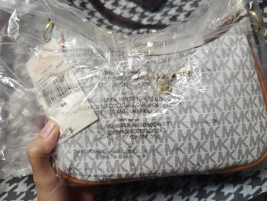 Michael Kors Monogram Shoulder Bag (Category: Luxury Bags & Wallets) located in Manila. Submitted by ishifishy (Listing ID 1458369098, Image 3). Description: - Michael Kors shoulder bag - Classic MK monogram print - Elegant gold chain strap - Stylish brown trim details - Ideal for everyday wear.