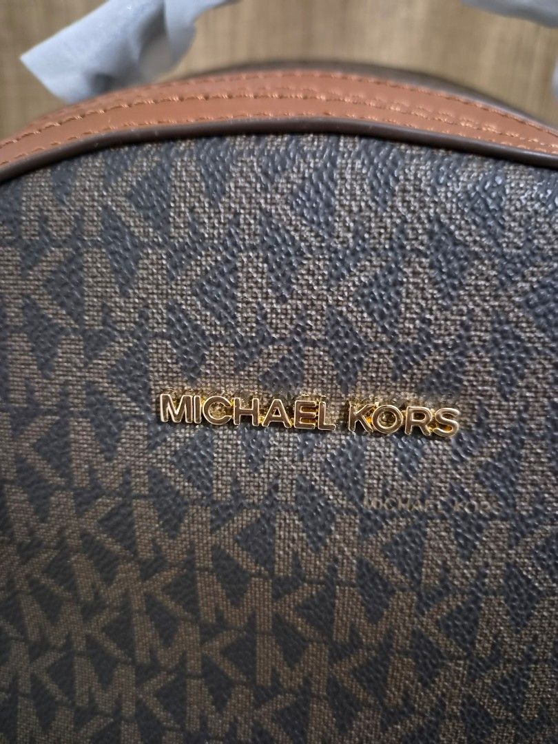 Michael Kors Signature Logo Backpack (Category: Backpacks) located in Paranaque City. Submitted by regf_01 (Listing ID 1458364943, Image 3). Description: - Authentic Michael Kors backpack - Signature MK print in brown and tan - Gold hardware details - Adjustable straps for comfort - Spacious interior for essentials - Ideal for everyday use or travel.