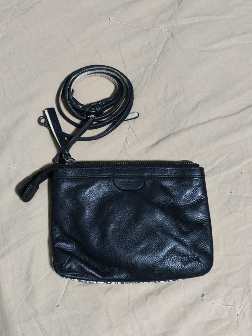 MIMCO Black & White Patterned Leather Pouch Clutch with Strap (Category: Clutches) located in Lucena. Submitted by cha_riz010726 (Listing ID 1458465160, Image 2). Description: - MIMCO pouch with unique black and white patterned exterior. - Black leather trim for a sophisticated touch. - Interior with multiple compartments for organized storage. - Includes a detachable leather strap for versatility. - Ideal for carrying cards, cash, or small perso