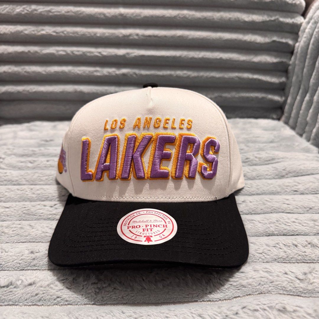 Mitchell & Ness Los Angeles Lakers NBA Draft Day Pro Fit Cap (Category: Caps & Hats) located in Agdangan. Submitted by kiiiiingg (Listing ID 1458329414, Image 1). Description: - Mitchell & Ness NBA Draft Day Pro Fit Cap - Features Los Angeles Lakers logo - Classic black brim with white crown design - Adjustable snapback closure for a custom fit - Essential headwear for any dedicated Lakers fan.