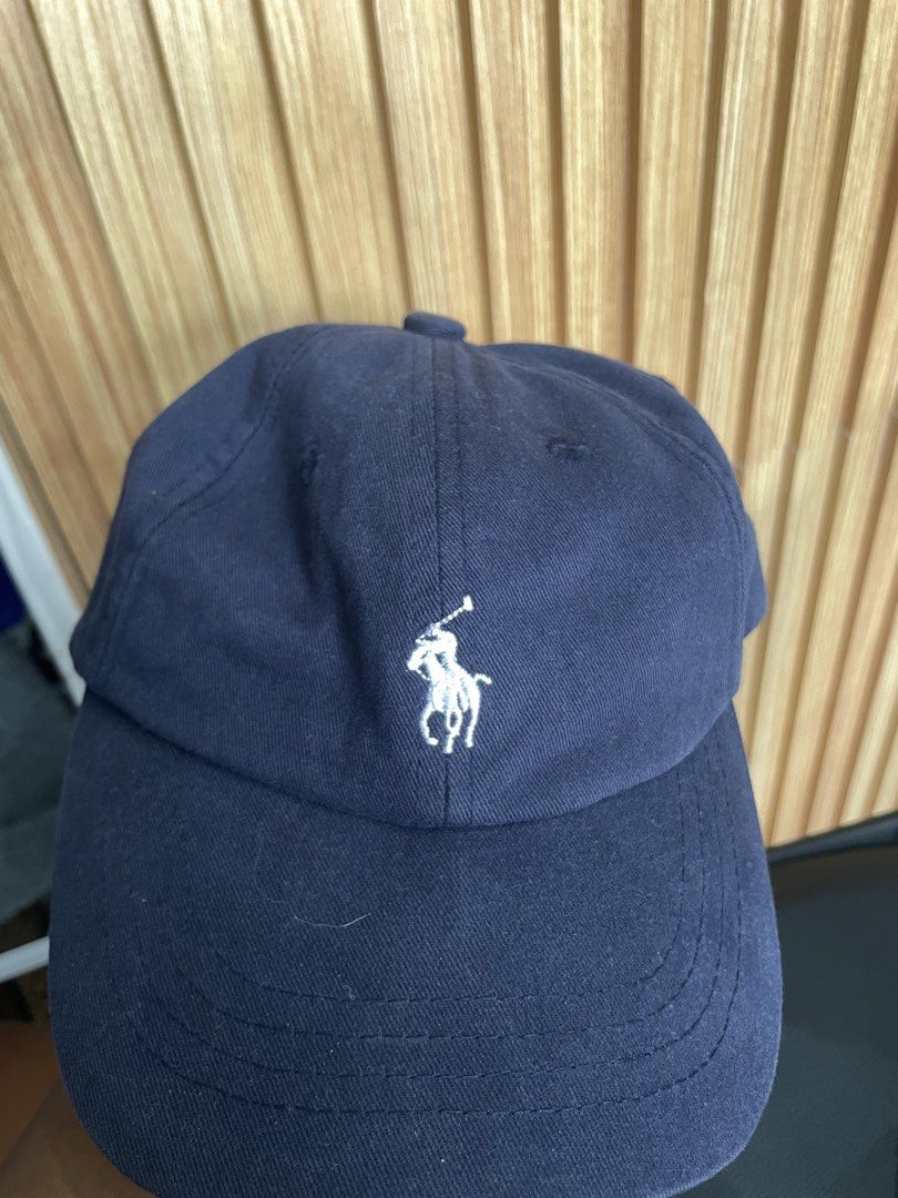 Navy Polo Ralph Lauren Cap (Category: Caps & Hats) located in Manila. Submitted by kyleee_ld (Listing ID 1458391360, Image 1). Description: - Classic navy blue cap from Polo Ralph Lauren. - Features iconic embroidered polo player logo on the front. - 'POLO' embroidered on the back. - Adjustable strap for a comfortable fit. - One size fits most. - Made in Cambodia..