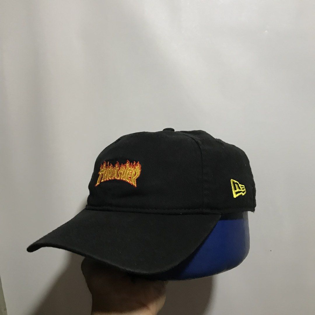 New Era x Thrasher Flame Logo Dad Cap Black (Category: Caps & Hats) located in Manila. Submitted by matias_10sstwr (Listing ID 1458326338, Image 2). Description: - Brand: New Era - Design: Black dad cap with embroidered Thrasher flame logo on front - Features: New Era logo on side, adjustable strap at back - Material: 100% Cotton - Style: Casual, everyday wear.