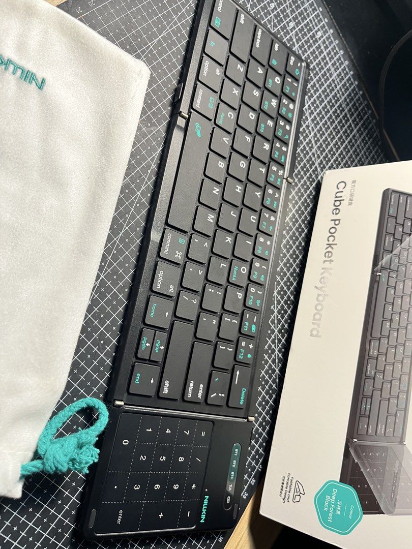 Nillkin Cube Pocket Keyboard (Category: Computer Keyboard) located in Caloocan City. Submitted by marcusriel88000 (Listing ID 1458392266, Image 2). Description: - Nillkin Cube Pocket Keyboard - Color: Deep Forest Black - Foldable design for ultimate portability - Built-in numpad for quick calculations - Includes a soft pouch for safe storage - Ideal for on-the-go typing and productivity.