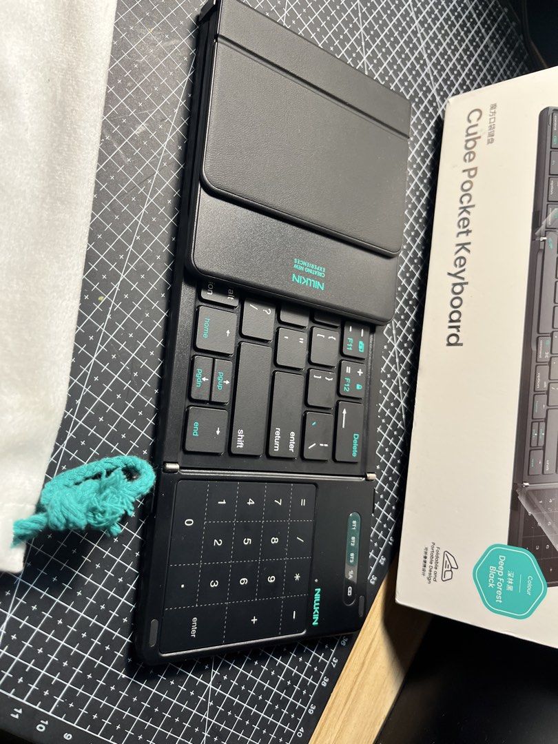 Nillkin Cube Pocket Keyboard (Category: Computer Keyboard) located in Caloocan City. Submitted by marcusriel88000 (Listing ID 1458392266, Image 3). Description: - Nillkin Cube Pocket Keyboard - Color: Deep Forest Black - Foldable design for ultimate portability - Built-in numpad for quick calculations - Includes a soft pouch for safe storage - Ideal for on-the-go typing and productivity.