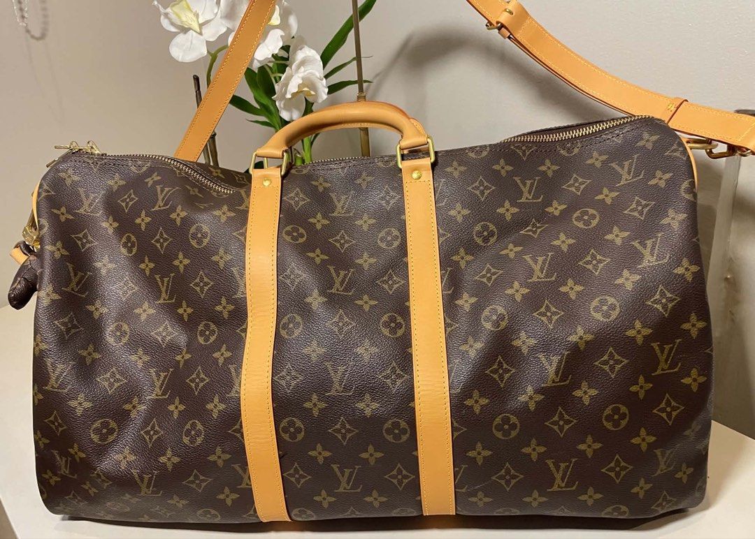 Original Louis Vuitton Monogram Keepall Duffle Bag with Dog Charm (Category: Luxury Bags & Wallets) located in Quezon City. Submitted by adelly23 (Listing ID 1458462021, Image 1). Description: - Classic Louis Vuitton Keepall duffle bag - Monogram canvas with tan leather trim and handles - Gold hardware - Includes a cute Louis Vuitton inspired dog charm with gold studs and chain - Ideal for weekend trips or as a carry-on - Spacious interior - Zipp