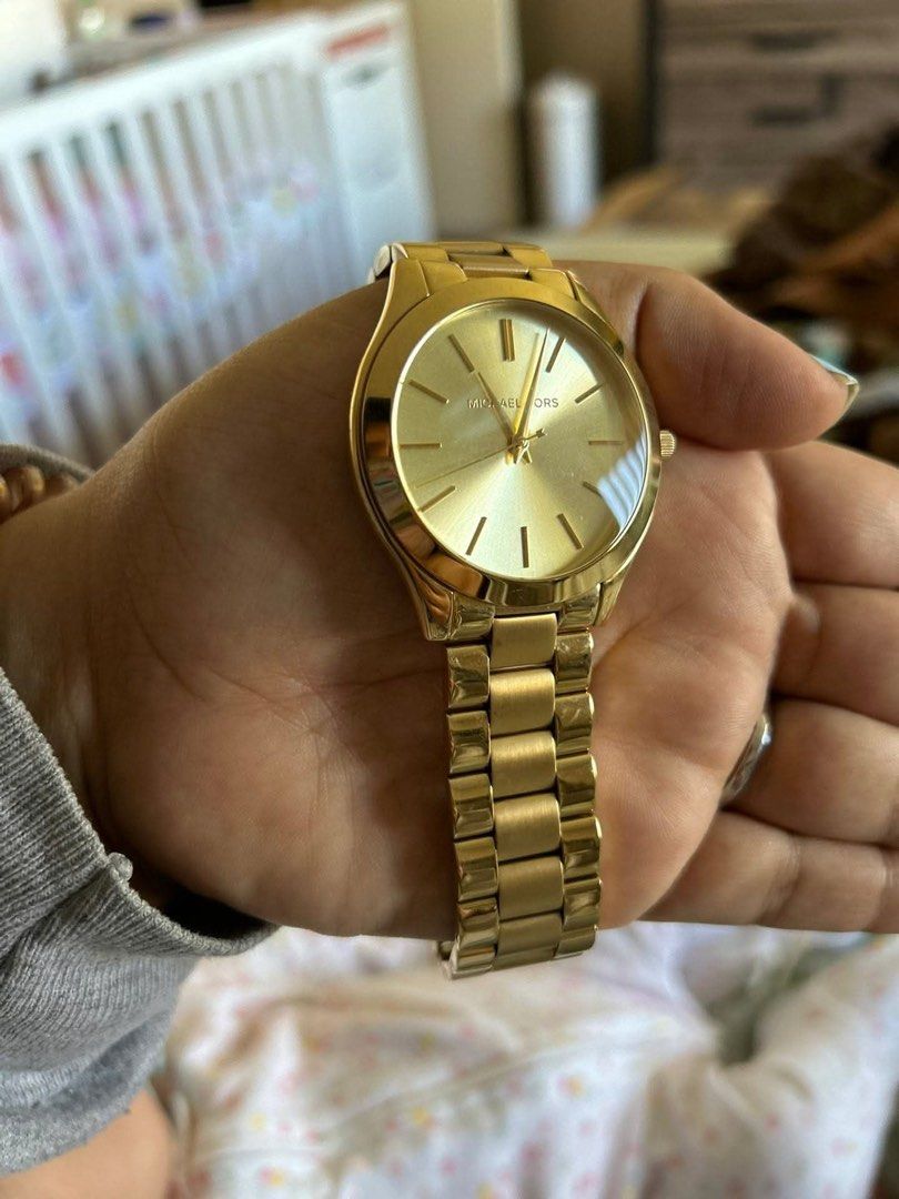ORIGINAL Michael Kors Gold Watch (Category: Women's Watches) located in Cavite. Submitted by marcelahongkay (Listing ID 1458379746, Image 2). Description: - Original - From US - Authentic Michael Kors watch in gold - Includes original box - Classic and minimalist design - Ideal for everyday wear - Features gold hands and markers - Durable stainless steel band - Looks stylish on the wrist.