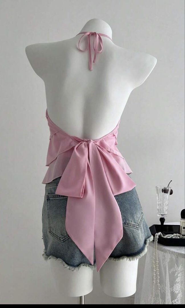 Pink Ruffled Halter Neck Top with Bow Back (Category: Sleeveless) located in Paranaque City. Submitted by shopmycloset_pretty.mercy (Listing ID 1458477392, Image 2). Description: - Adorable pink halter top - Features tiered ruffles in the front - Chic tie-back bow detail - Made from light and flowy fabric - Versatile: great for nights out or casual days - Pairs perfectly with shorts or skirts - True to size fit.