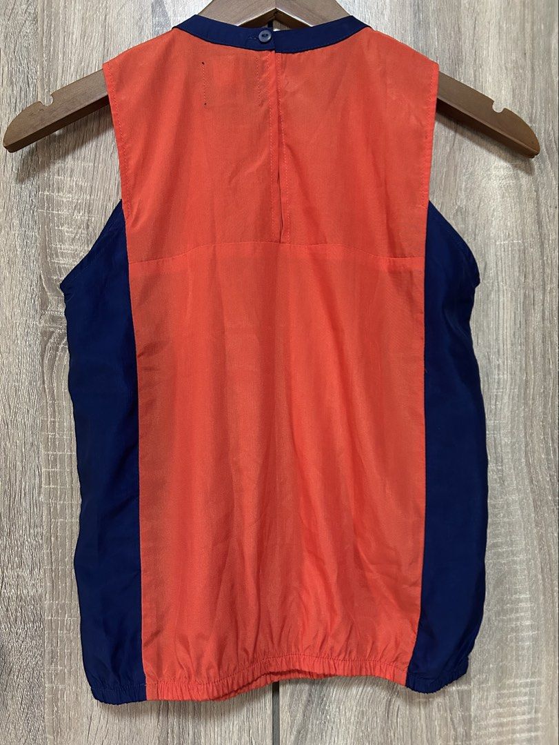 Plains & Prints Blouse (Category: Blouses) located in Bulacan. Submitted by relove.re (Listing ID 1458394925, Image 2). Description: - Plain blouse - Orange and Dark Blue color - Can fit XS or S - A bit close neck - Bottom Gaterized design .