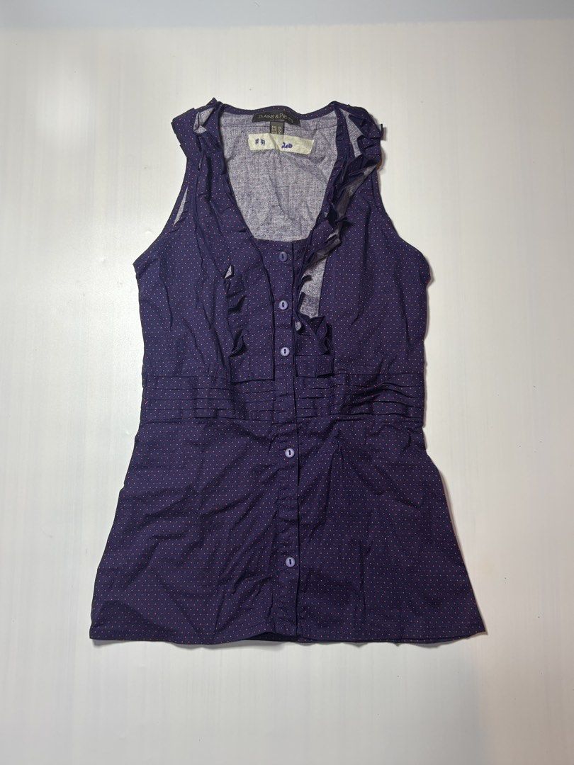 Plains & Prints Navy Polka Dot Ruffled Sleeveless Top (Category: Sleeveless) located in Baguio. Submitted by cosmogyralfinds (Listing ID 1458326639, Image 1). Description: - Navy blue sleeveless top - Pink polka dot pattern - Ruffled neckline - Button-down front - Cinched waist for a flattering fit - Brand: Plains & Prints - Ideal for casual or dressed-up looks.