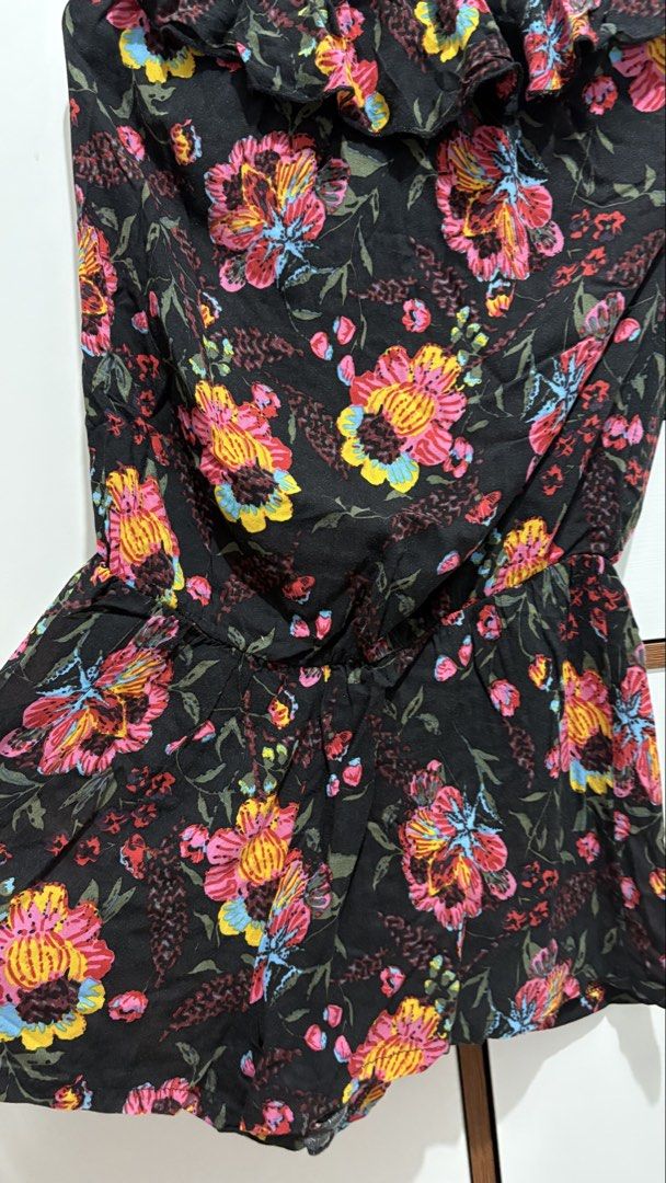 Poetry Black Floral Strapless Romper (Category: Rompers) located in Taguig. Submitted by gailyyyyyyyy (Listing ID 1458411094, Image 3). Description: - Black strapless romper - Vibrant floral print - Elasticated waist for comfort - Ruffled neckline detail - Ideal for casual wear or beach trips - Easy to wear and stylish - Fits XS bust 32.