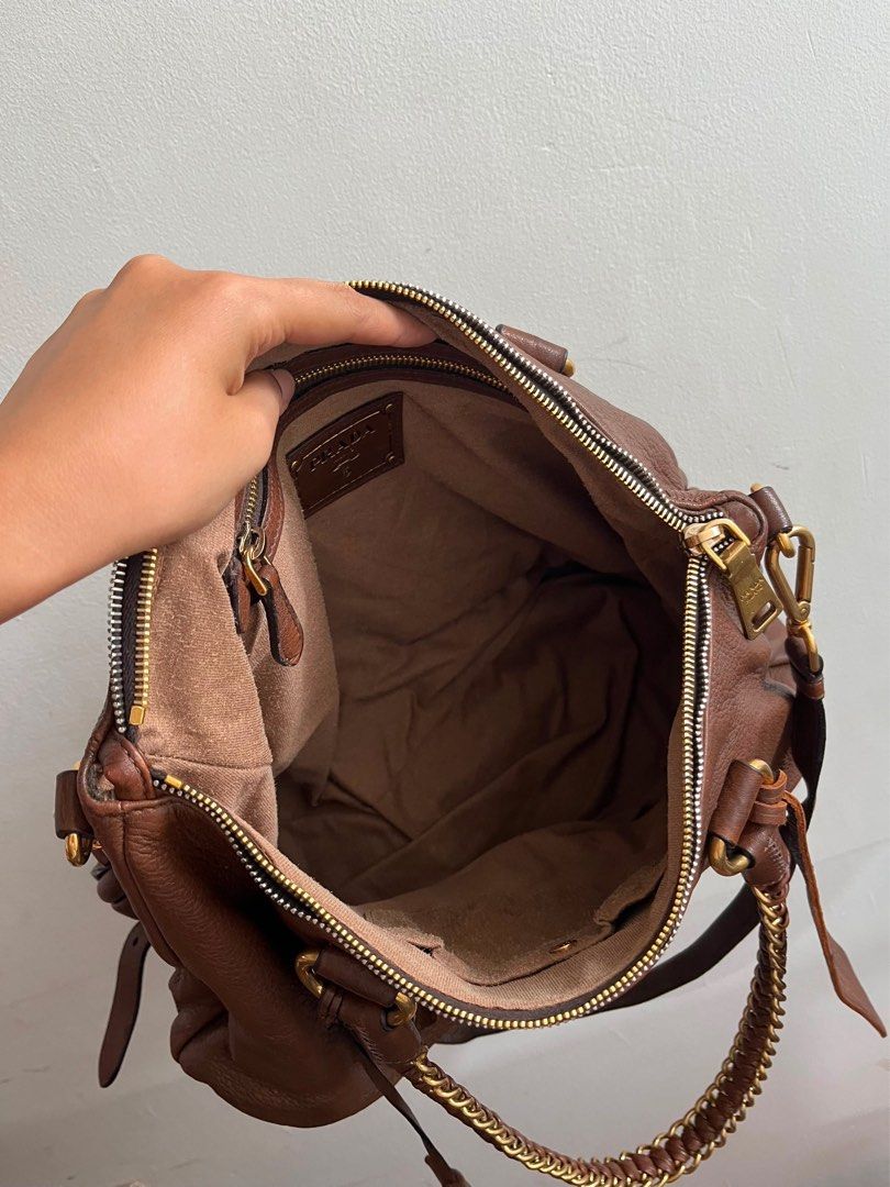 Prada Milano Brown Leather Chain Shoulder Bag (Category: Luxury Bags & Wallets) located in Sariaya. Submitted by luxecam (Listing ID 1458380332, Image 3). Description: - Authentic Prada Bag - Made in Italy - Rich Brown Pebbled Leather - Elegant Gold Chain Detail - Spacious Interior with Multiple Compartments - Smooth Zipper Action - Comes with Original Dust Bag - Ideal Everyday Bag.