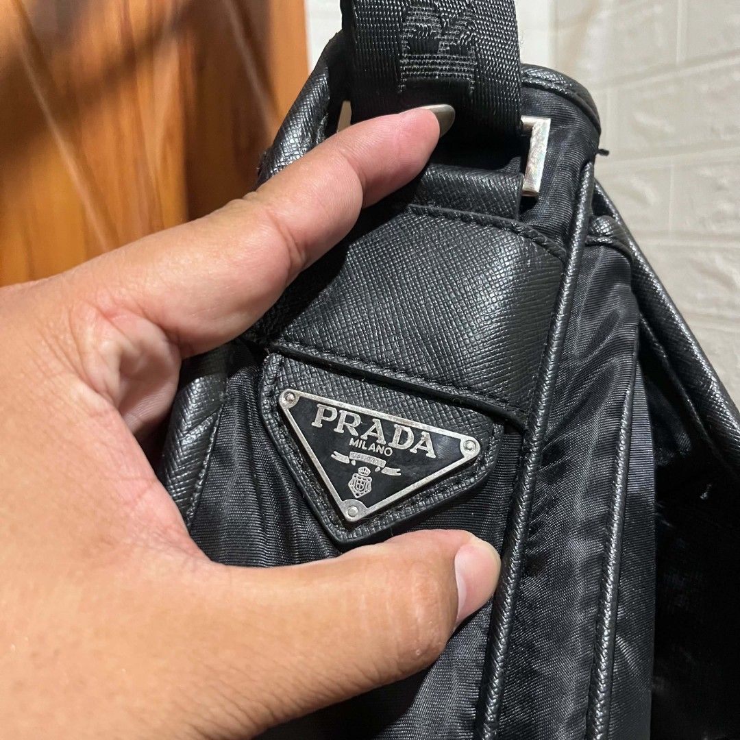 Prada Nylon Messenger Bag Black (Category: Luxury Bags & Wallets) located in Manila. Submitted by abj_thriftshop (Listing ID 1458448989, Image 3). Description: - Prada messenger bag - Color: Black - Material: Nylon with leather trim - Features: Adjustable strap with Prada logo, front flap buckle closure - Interior detail: Tag with '175' - Ideal for: Everyday use.