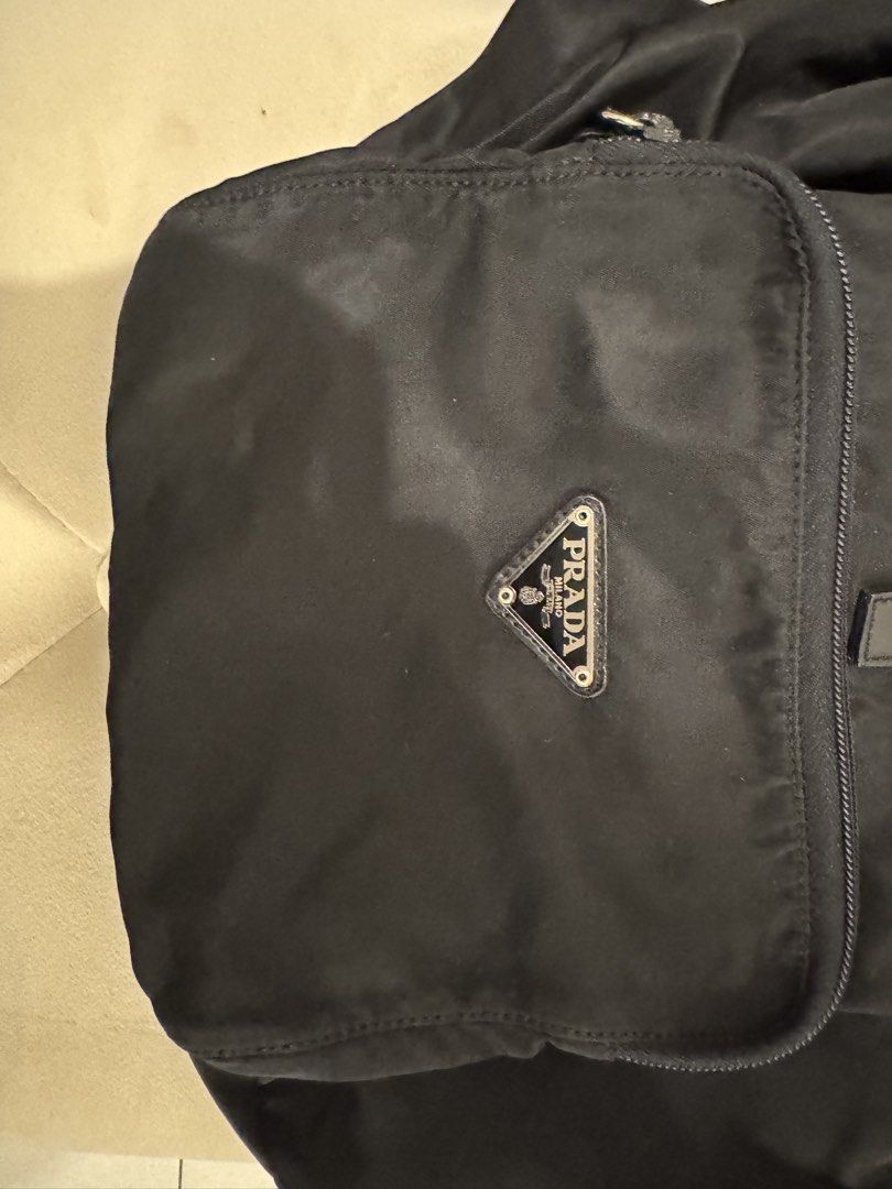 Prada Tessuto Nylon Backpack with Dust Bag (Category: Luxury Bags & Wallets) located in Cainta. Submitted by ginamit (Listing ID 1452701481, Image 2). Description: - Authentic Prada backpack - Black nylon material - Secure drawstring closure with buckle strap - Convenient front zip pocket - Includes original Prada dust bag - Ideal for everyday use or travel ***100% authentic. Full refund plus ₱5,000 if the item is confirmed counterfeit by the bra
