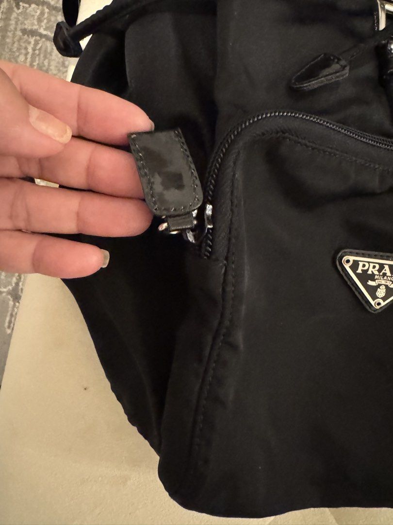 Prada Tessuto Nylon Backpack with Dust Bag (Category: Luxury Bags & Wallets) located in Cainta. Submitted by ginamit (Listing ID 1452701481, Image 3). Description: - Authentic Prada backpack - Black nylon material - Secure drawstring closure with buckle strap - Convenient front zip pocket - Includes original Prada dust bag - Ideal for everyday use or travel ***100% authentic. Full refund plus ₱5,000 if the item is confirmed counterfeit by the bra