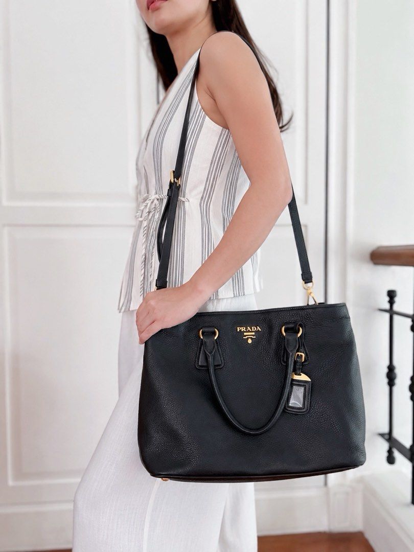 Prada Vitello Daino Two Way Bag (Category: Luxury Bags & Wallets) located in Muntinlupa City. Submitted by closet.confessions (Listing ID 1458323864, Image 2). Description: Classic. Iconic. Always in demand. A practical luxury piece you can carry everyday, anywhere. 🖤 Best office bag too. Can fit laptop. Rank SA, very rare to find one this pristine! comes with long strap & dustbag.