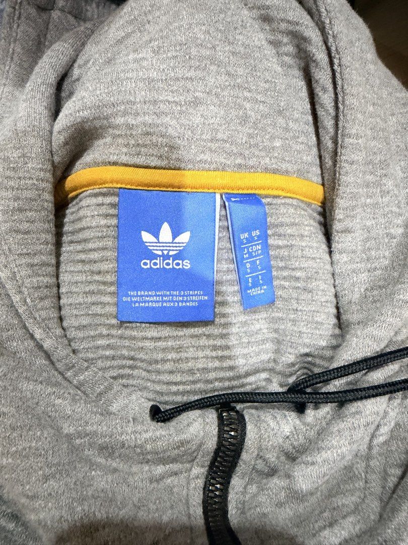 Pre-loved Adidas Grey Hoodie Pullover Quarter Zip size small (Category: Coats, Jackets and Outerwear) located in Quezon City. Submitted by muradito_01 (Listing ID 1458374102, Image 2). Description: - Grey Adidas hoodie - Quarter zip with drawstring hood - Front kangaroo pocket - Ribbed cuffs and hem - Size: UK US S/P, J CON S/P, F S, D S - Made in China - Ideal for casual wear.