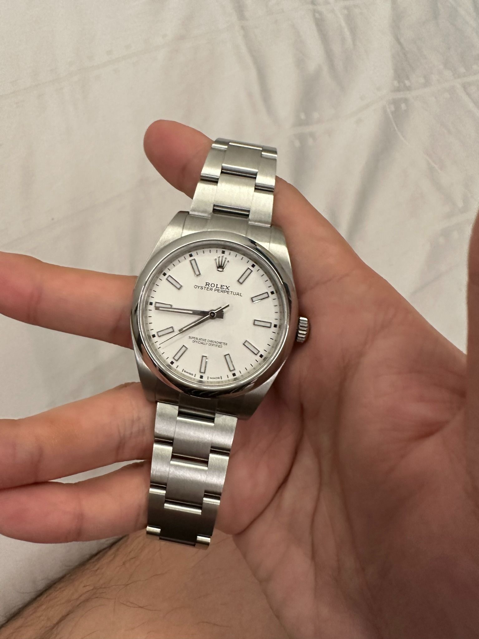 Rolex Oyster Perpetual 114300 White Dial Watch Full Set (Category: Watches) located in Singapore. Submitted by brendonclf (Listing ID 1458345189, Image 3). Description: Selling a 2018 Rolex OP 114300 in eggshell white. - Rolex Oyster Perpetual watch - Classic white dial with silver markers - Automatic movement - Stainless steel case and bracelet - Luminous hands and markers (glow in the dark) - Versatile timepiece for any occasion.