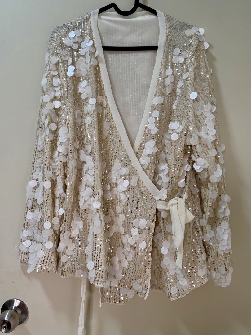 Sequin Jacket (Category: Coats, Jackets and Outerwear) located in Kuala Lumpur. Submitted by misslittlemars (Listing ID 1458378031, Image 1). Description: - Cream colored jacket with all-over white sequins - Elegant wrap style with a secure tie closure - Free size, designed to fit most body types - Ideal for parties or elevating any outfit .