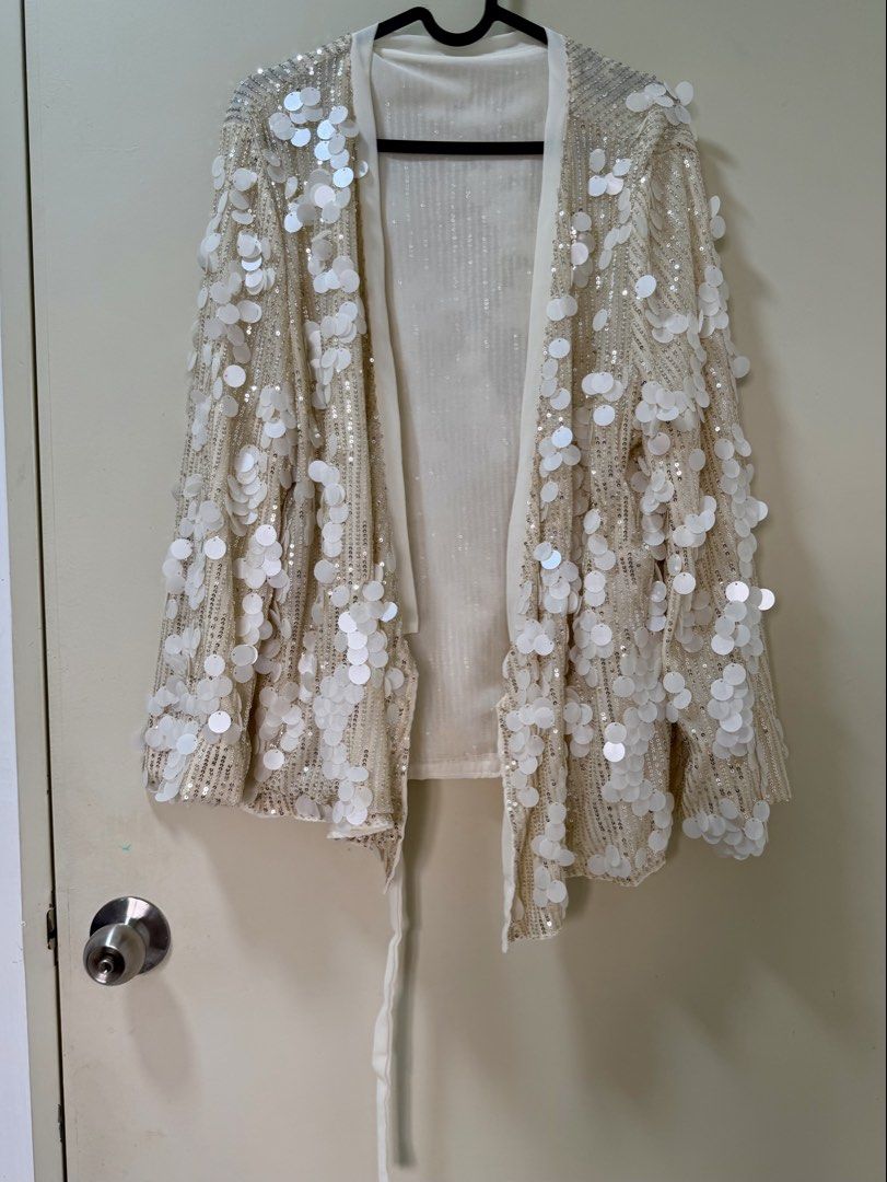 Sequin Jacket (Category: Coats, Jackets and Outerwear) located in Kuala Lumpur. Submitted by misslittlemars (Listing ID 1458378031, Image 3). Description: - Cream colored jacket with all-over white sequins - Elegant wrap style with a secure tie closure - Free size, designed to fit most body types - Ideal for parties or elevating any outfit .