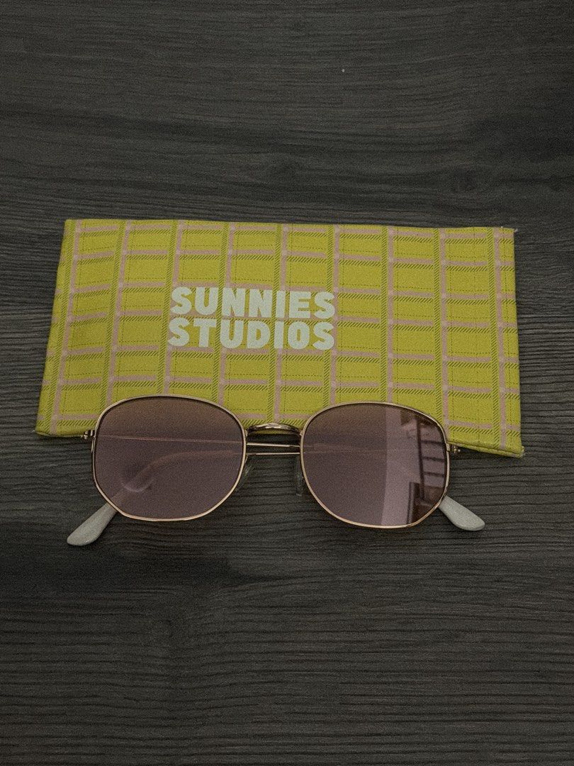 Sunnies Studios Sunglasses with Case (Category: Sunglasses & Eyewear) located in Manila. Submitted by sushi.lover (Listing ID 1458369808, Image 1). Description: - Brand: Sunnies Studios - Frame Color: Gold - Lens Color: Light Pink - Condition: Great for sunny days - Includes: Original yellow plaid case - Feel free to ask questions!.