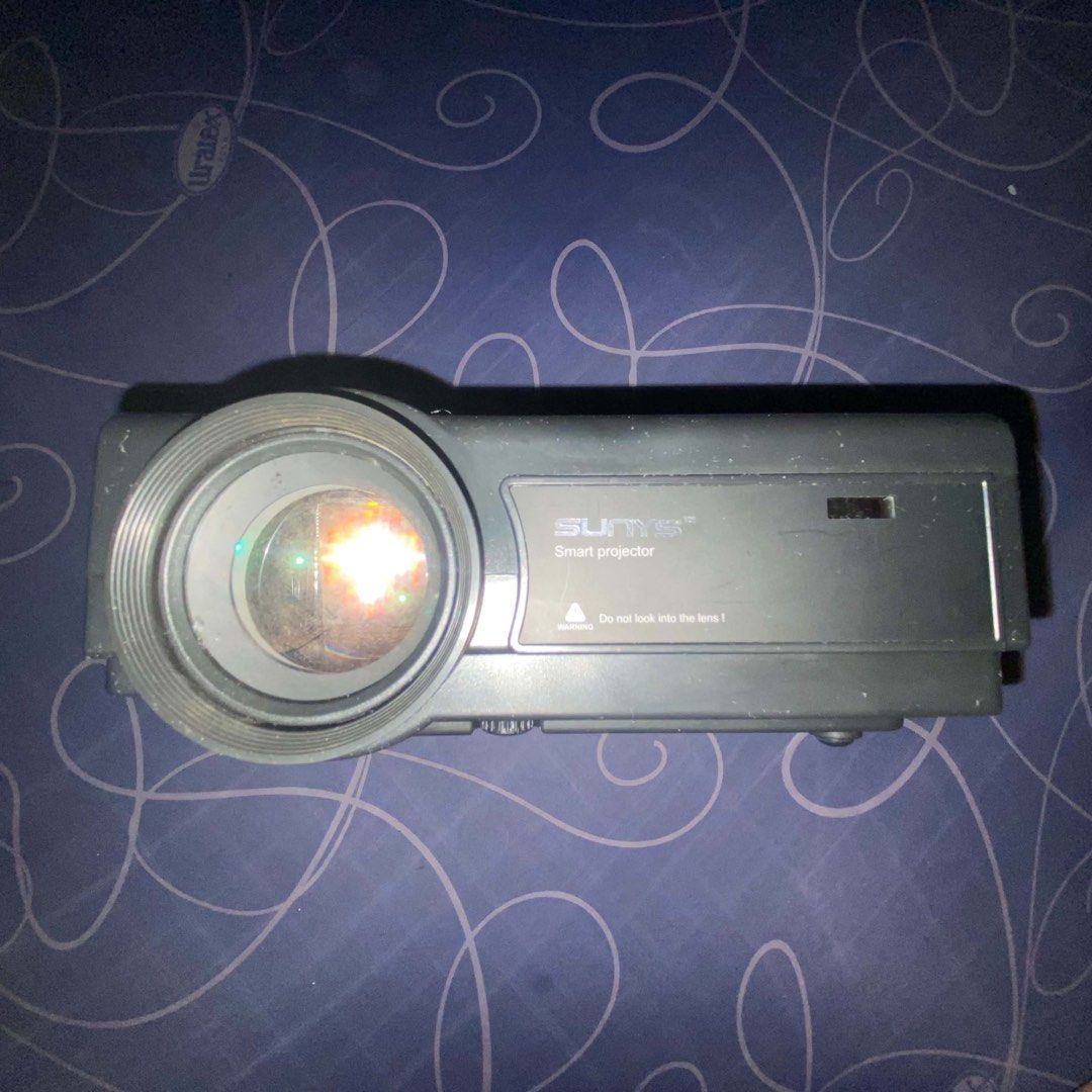 SUNYS Smart Projector (Category: Projectors) located in Manila. Submitted by r_vmvnd (Listing ID 1458461092, Image 3). Description: - SUNYS Smart Projector - Ideal for movie nights and presentations - Connectivity: HDMI, USB, AV, VGA ports - Easy focus and keystone adjustment wheels on top - In excellent working condition.
