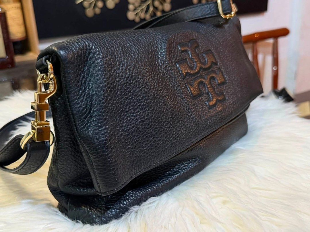 Tory Burch Black Leather Convertible Tote Bag (Category: Luxury Bags & Wallets) located in Manila. Submitted by cappuccinomacchiato08 (Listing ID 1458307360, Image 3). Description: - Authentic Tory Burch black leather bag - Convertible design: wear as a tote or fold into a clutch - Elegant gold hardware details - Beautiful pebbled leather texture - Ample space for your daily essentials - Perfect for day-to-night transitions Hard to find🖤 This ra