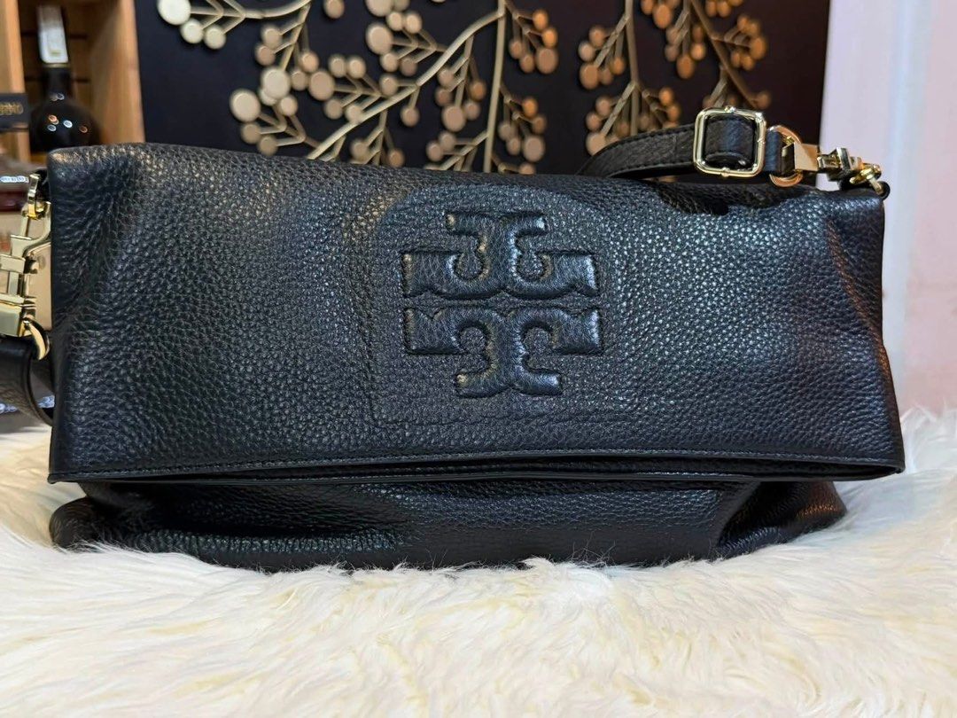 Tory Burch Black Leather Convertible Tote Bag (Category: Luxury Bags & Wallets) located in Manila. Submitted by cappuccinomacchiato08 (Listing ID 1458307360, Image 2). Description: - Authentic Tory Burch black leather bag - Convertible design: wear as a tote or fold into a clutch - Elegant gold hardware details - Beautiful pebbled leather texture - Ample space for your daily essentials - Perfect for day-to-night transitions Hard to find🖤 This ra