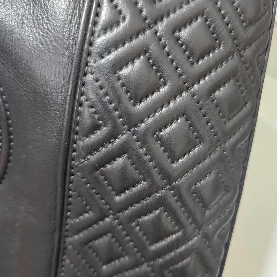 Tory Burch Black Leather Quilted Chain Shoulder Bag (Category: Luxury Bags & Wallets) located in Paranaque City. Submitted by ysabelsbag (Listing ID 1458478231, Image 3). Description: - Authentic Tory Burch shoulder bag in black leather - Elegant diamond quilting design - Stylish gold chain strap - Charming tassel detail on the side - Multiple interior compartments for organization - Interior zip pocket for secure storage - Clean and well-maintai
