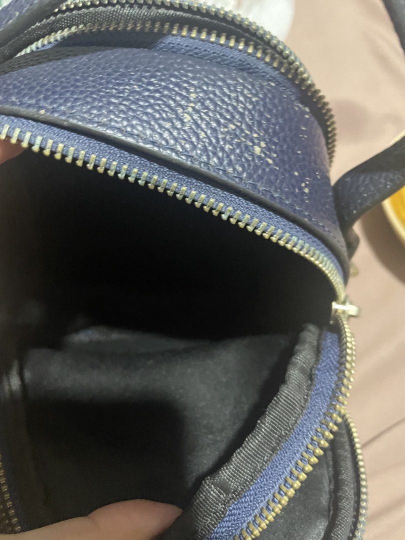 Tory Burch Navy Blue Leather Mini Bag (Category: Luxury Bags & Wallets) located in Marikina City. Submitted by diazjeniel90559 (Listing ID 1458346390, Image 3). Description: /with flaws see on pic - Navy blue Tory Burch mini bag - Pebbled leather material - Zipper closure - Interior: 1 zippered pocket, 1 slip pocket - Exterior: Some wear on handle and edges - Interior: Clean - Condition: Selling as is.