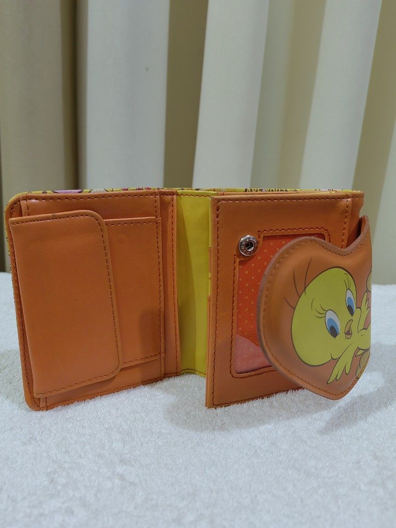 Tweety Bird Wallet (Category: Wallets & Card holders) located in Makati City. Submitted by prelovedtreatedwithlove (Listing ID 1458440226, Image 3). Description: - Adorable Tweety Bird wallet - Bright yellow with all-over Tweety print - Features a cute heart-shaped flap with Tweety - Includes convenient card slots - Has a practical coin pouch - Fun and functional for fans of Tweety Bird - Cute for teens -no rubs but with sign of usage .