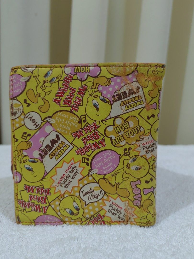 Tweety Bird Wallet (Category: Wallets & Card holders) located in Makati City. Submitted by prelovedtreatedwithlove (Listing ID 1458440226, Image 2). Description: - Adorable Tweety Bird wallet - Bright yellow with all-over Tweety print - Features a cute heart-shaped flap with Tweety - Includes convenient card slots - Has a practical coin pouch - Fun and functional for fans of Tweety Bird - Cute for teens -no rubs but with sign of usage .