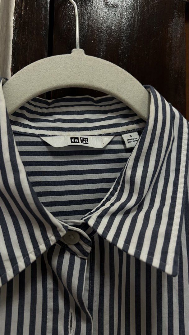 Uniqlo Striped Button-Down Shirt (Long Sleeve) (Category: Longsleeves) located in Batangas. Submitted by thecuratedrack_ph (Listing ID 1458403343, Image 2). Description: Classic navy blue and white pinstripe button-down, collared, long sleeves with button cuffs. Lightweight cotton fabric — easy to dress up for work or style down for a casual look..