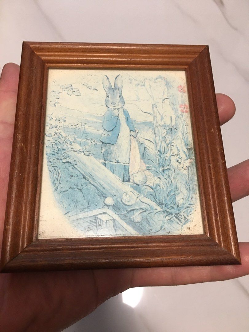 Vintage Peter Rabbit Framed Picture Art (Category: Frames & Pictures) located in Pasay City. Submitted by gilbertso62551 (Listing ID 1458397257, Image 2). Description: - Adorable framed Peter Rabbit artwork. - Sturdy wooden frame. - Compact size, ideal for any space. - Features a charming vintage blue and white design. - Perfect for nurseries, kids' rooms, or home decor. - As is,where is - Excellent .
