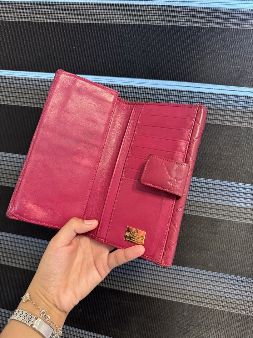 Vivienne Westwood Wallet (Category: Luxury Bags & Wallets) located in General Mariano Alvarez. Submitted by kuhwenyyy (Listing ID 1458331339, Image 2). Description: Authentic Vivienne Westwood Long Flap Wallet Front flap closure with gold tone Vivienne Westwood Orb emblem Made in Italy Lightly used with minor signs of wear.