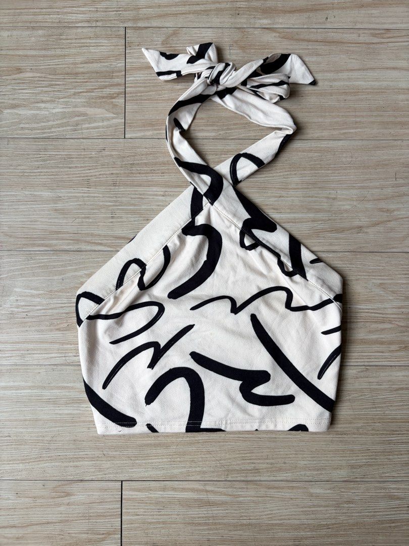White & Black Abstract Print Halter Neck Crop Top (Category: Sleeveless) located in Quezon City. Submitted by j.steffy (Listing ID 1458321396, Image 1). Description: - Size: XS-M -Cute halter neck crop top - Fun abstract print - Ties at neck and back - Smocked detail at the back for a snug fit - Lightweight and breathable fabric - Perfect for casual outings or beach trips.