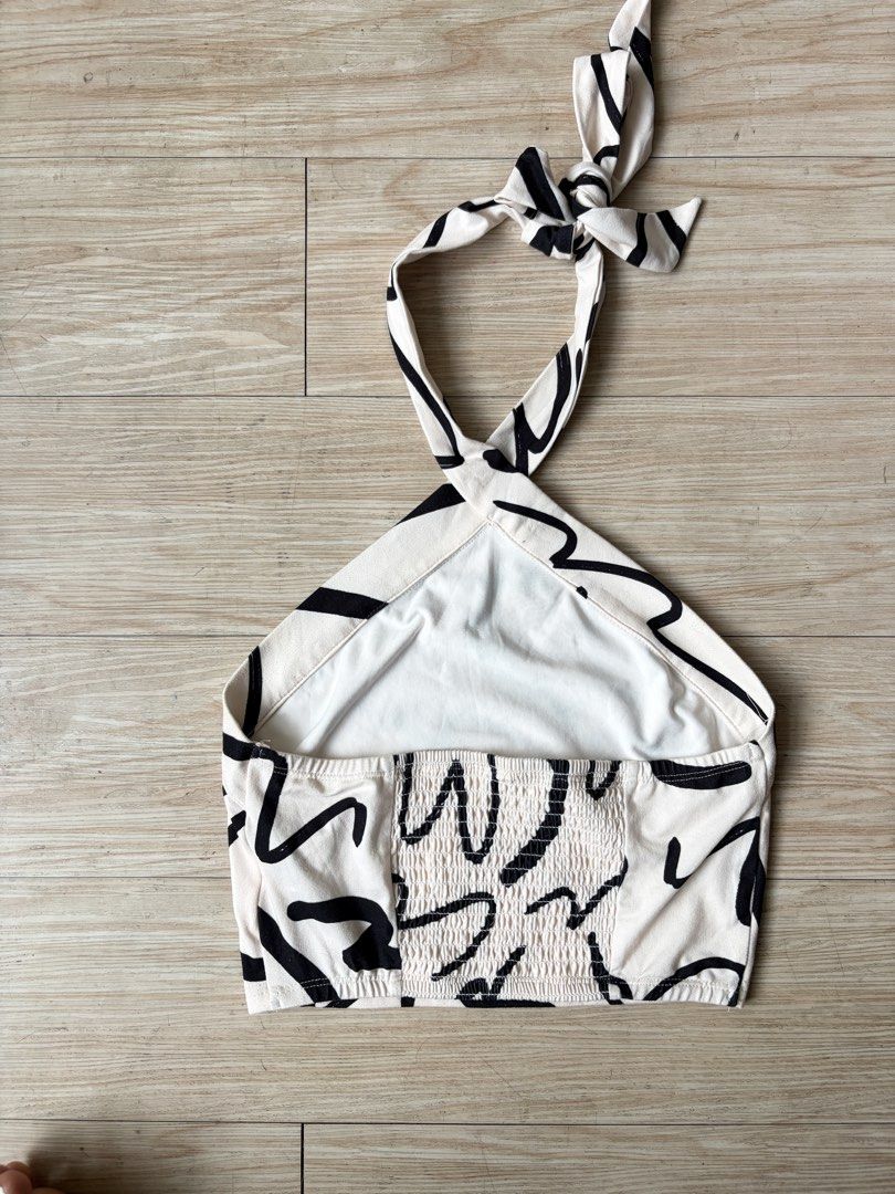 White & Black Abstract Print Halter Neck Crop Top (Category: Sleeveless) located in Quezon City. Submitted by j.steffy (Listing ID 1458321396, Image 2). Description: - Size: XS-M -Cute halter neck crop top - Fun abstract print - Ties at neck and back - Smocked detail at the back for a snug fit - Lightweight and breathable fabric - Perfect for casual outings or beach trips.