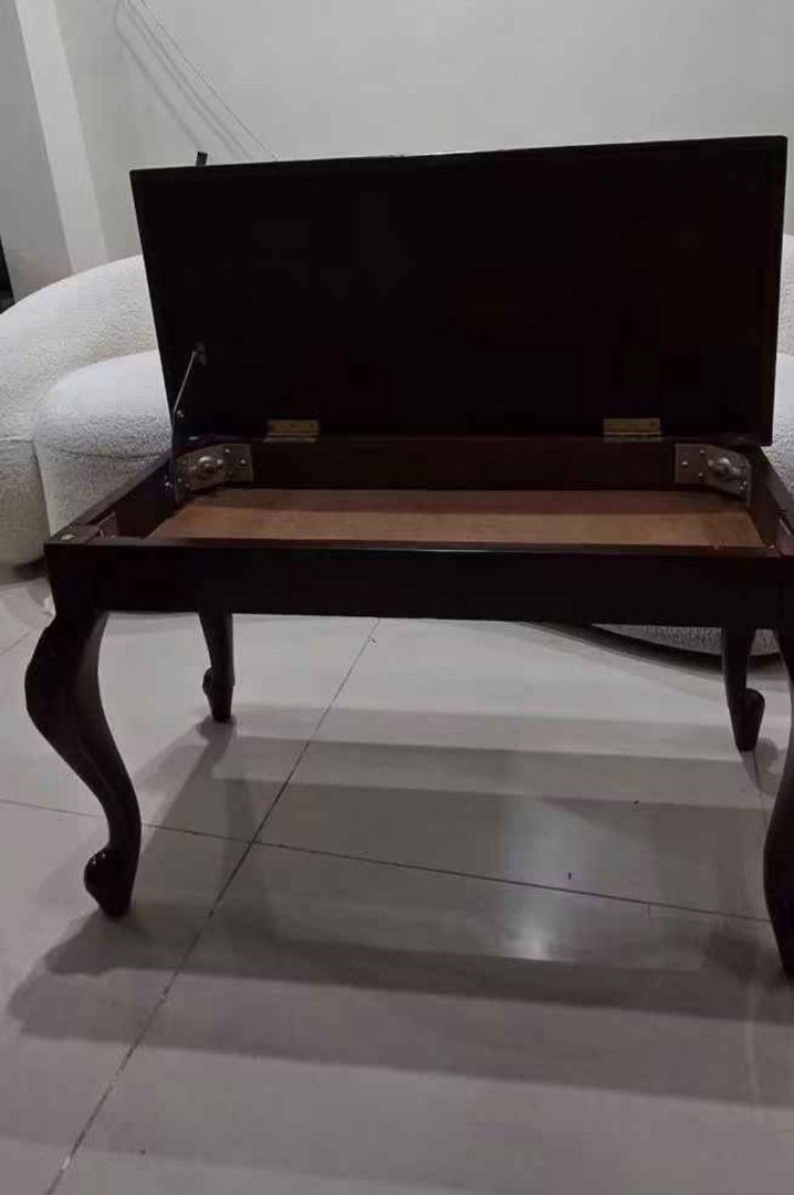 Wooden Coffee Table with Storage (Category: Tables & Sets) located in Manila. Submitted by otansebastian01 (Listing ID 1458379106, Image 2). Description: - Dark wood coffee table - Features a convenient lift-top for hidden storage - Curved legs for a classic aesthetic - Versatile design complements most decor styles - Ideal size for living room spaces.