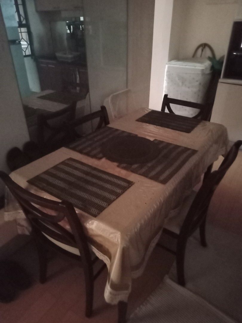 Wooden Dining Table and Chairs Set (Category: Tables & Sets) located in Cainta. Submitted by vinzrulez (Listing ID 1458394240, Image 1). Description: - Wooden dining table set perfect for small dining areas. - Table features a light-colored tablecloth and placemats. - Includes 4 dark wood chairs with comfortable curved backrests. - Ready to be a part of your new home..
