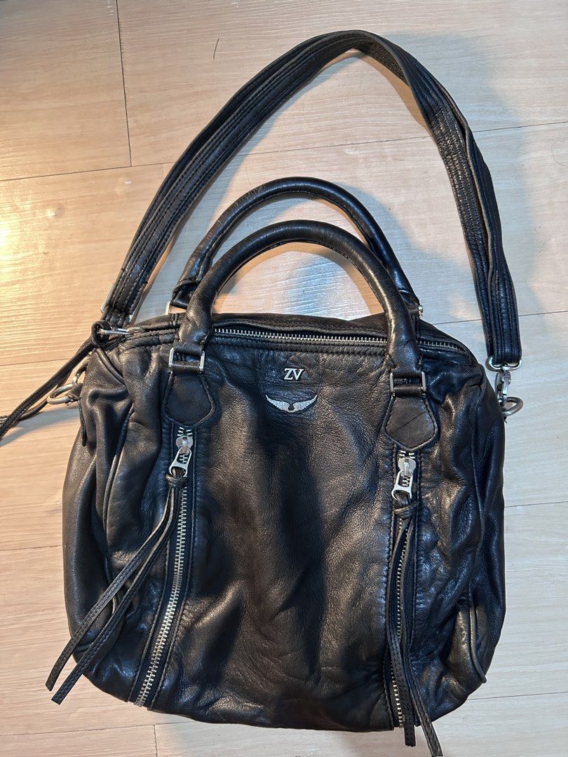 Zadig & Voltaire Black Leather Shoulder Bag (Category: Luxury Bags & Wallets) located in Dipolog. Submitted by adrian281994 (Listing ID 1458444524, Image 3). Description: - Genuine Zadig & Voltaire black leather bag Authentic - Versatile: top handles and detachable shoulder strap - Convenient storage: zippered pockets on front, sides, and interior - Signature branded zippers - Shows natural leather creasing from use - Ideal classic everyday carry