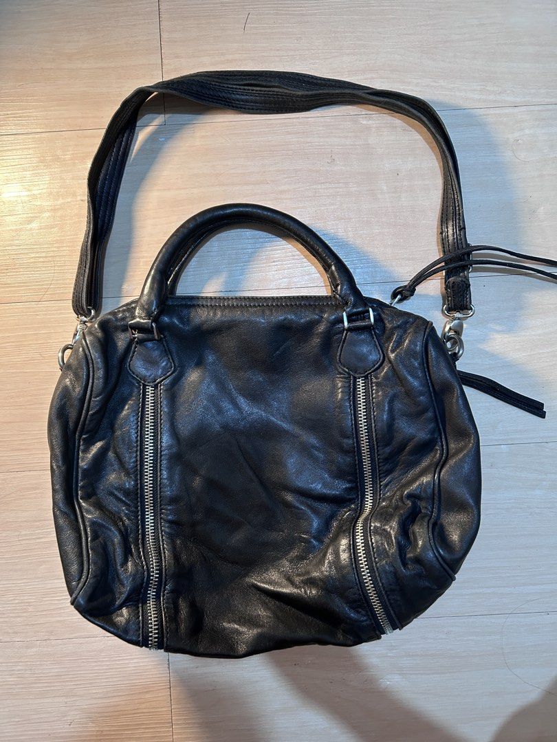Zadig & Voltaire Black Leather Shoulder Bag (Category: Luxury Bags & Wallets) located in Dipolog. Submitted by adrian281994 (Listing ID 1458444524, Image 2). Description: - Genuine Zadig & Voltaire black leather bag Authentic - Versatile: top handles and detachable shoulder strap - Convenient storage: zippered pockets on front, sides, and interior - Signature branded zippers - Shows natural leather creasing from use - Ideal classic everyday carry