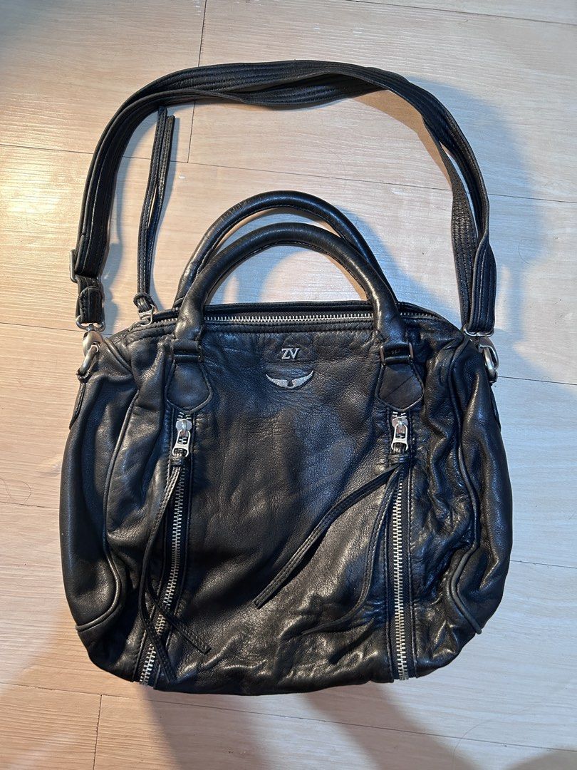 Zadig & Voltaire Black Leather Shoulder Bag (Category: Luxury Bags & Wallets) located in Dipolog. Submitted by adrian281994 (Listing ID 1458444524, Image 1). Description: - Genuine Zadig & Voltaire black leather bag Authentic - Versatile: top handles and detachable shoulder strap - Convenient storage: zippered pockets on front, sides, and interior - Signature branded zippers - Shows natural leather creasing from use - Ideal classic everyday carry