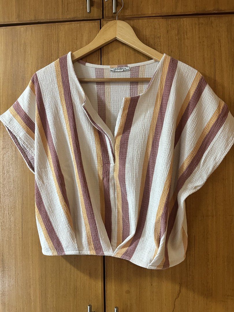 ZARA TRF Striped Twist Front V-Neck Top (Category: Blouses) located in Pasig City. Submitted by zelinavillaflor (Listing ID 1458356117, Image 2). Description: - ZARA TRF striped top - V-neck with button closure - Twist front detail at the hem - Short sleeves - Textured fabric - Ideal for casual wear.