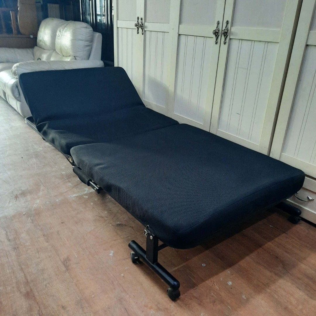 2nd hand black mesh folding bed (Category: Bed Frames & Mattresses) located in Manila. Submitted by ivan_furnitures421 (Listing ID 1453573041, Image 2). Description: - Black foldable sofa bed - Versatile: Use as a bed - Easy mobility with built-in wheels - Adjustable backrest for comfort - Ideal for small apartments or guest rooms - Folds out completely flat - Durable and sturdy metal frame.