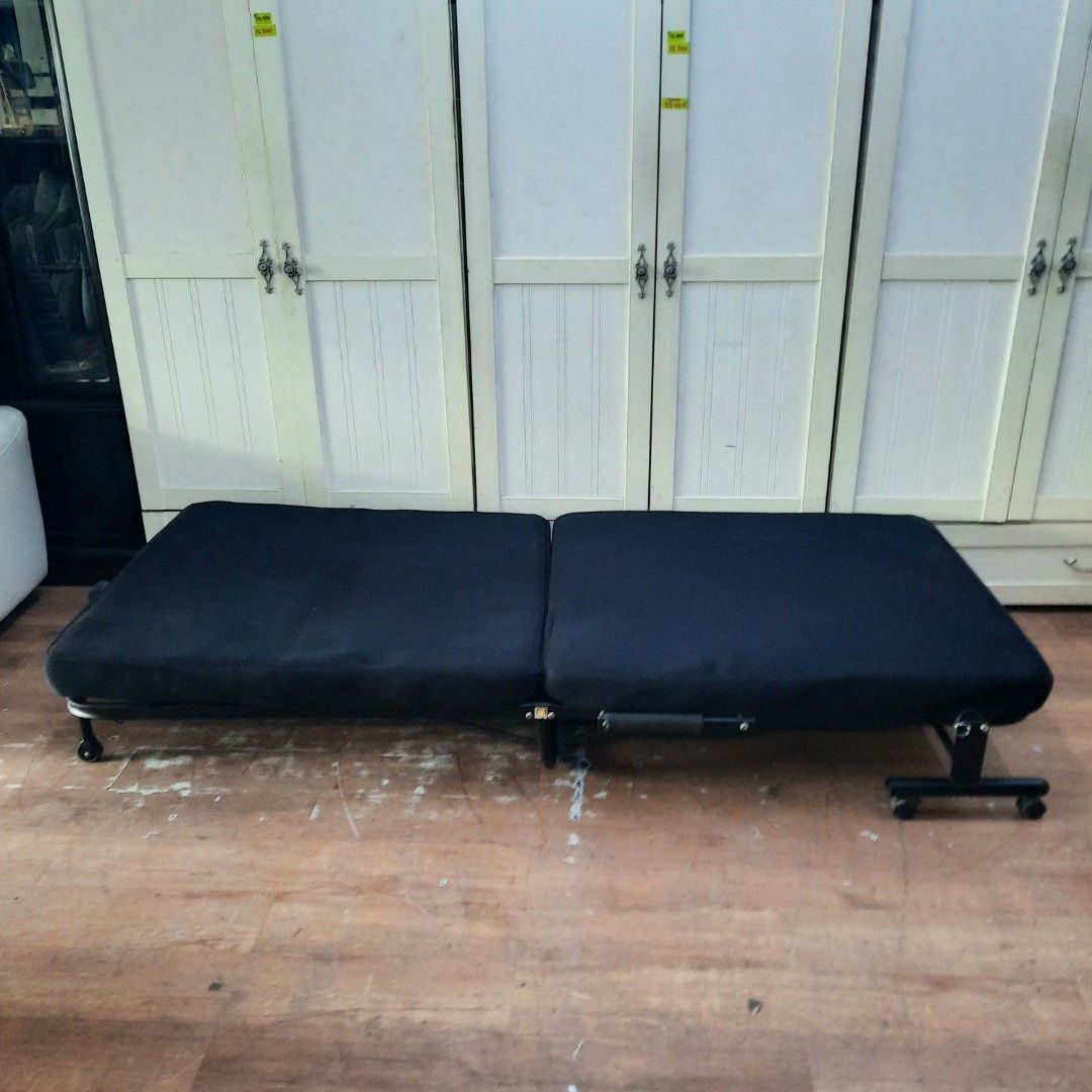 2nd hand black mesh folding bed (Category: Bed Frames & Mattresses) located in Manila. Submitted by ivan_furnitures421 (Listing ID 1453573041, Image 3). Description: - Black foldable sofa bed - Versatile: Use as a bed - Easy mobility with built-in wheels - Adjustable backrest for comfort - Ideal for small apartments or guest rooms - Folds out completely flat - Durable and sturdy metal frame.