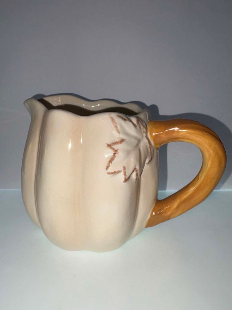 Abington Designs Ceramic Pumpkin Creamer Pitcher | Fall Harvest Decor (Category: Coffee & Tea Tableware) located in Caloocan City. Submitted by rabbithole2026 (Listing ID 1453589589, Image 2). Description: Description: Beautiful Abington Designs pumpkin-shaped ceramic creamer pitcher featuring a cream-colored pumpkin body with a brown stem handle. Perfect for serving cream, milk, syrup, or as a decorative piece for fall, Thanksgiving, or farmhous