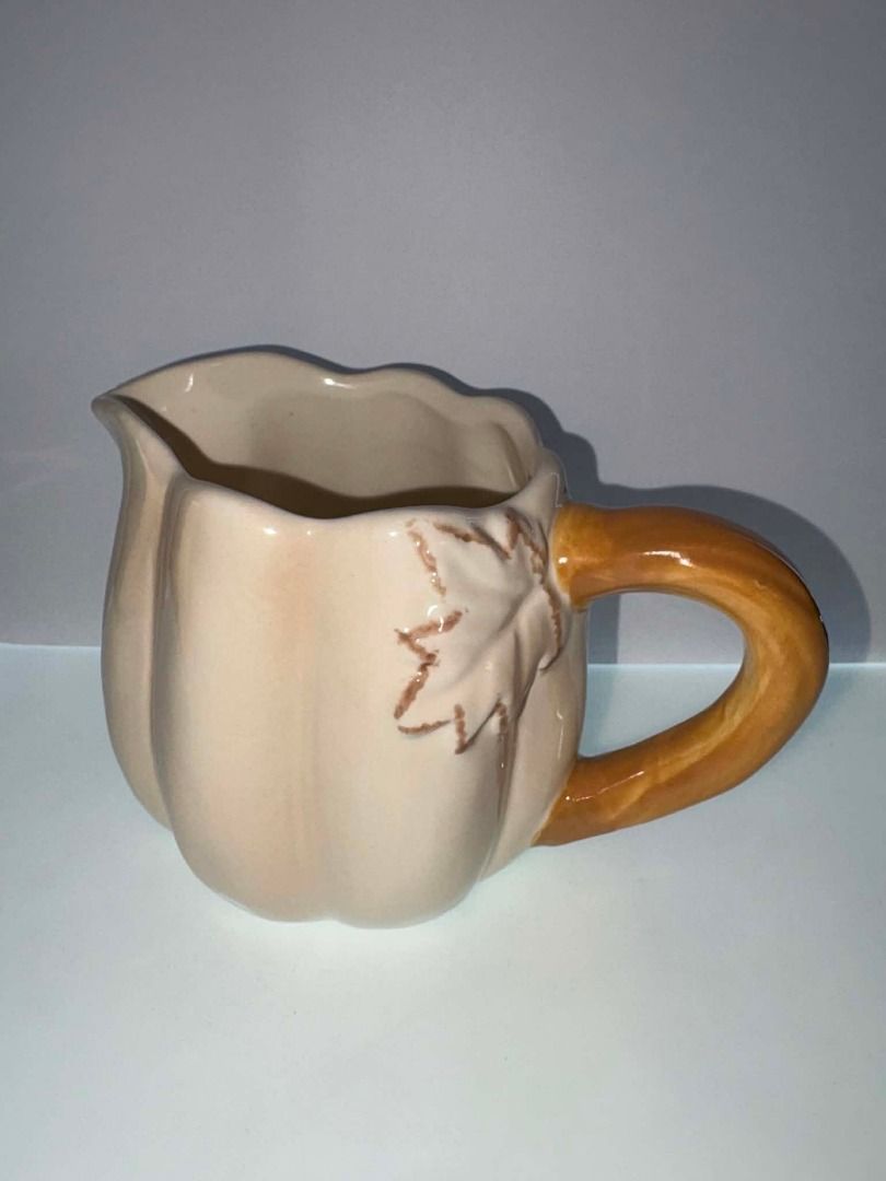 Abington Designs Ceramic Pumpkin Creamer Pitcher | Fall Harvest Decor (Category: Coffee & Tea Tableware) located in Caloocan City. Submitted by rabbithole2026 (Listing ID 1453589589, Image 1). Description: Description: Beautiful Abington Designs pumpkin-shaped ceramic creamer pitcher featuring a cream-colored pumpkin body with a brown stem handle. Perfect for serving cream, milk, syrup, or as a decorative piece for fall, Thanksgiving, or farmhous