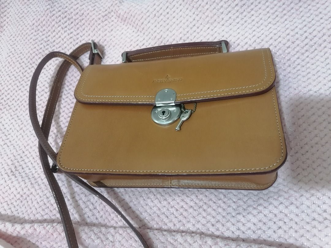 andre valentino (Category: Luxury Bags & Wallets) located in Paranaque City. Submitted by neveahthrift (Listing ID 1453584375, Image 1). Description: Brand: Andre Valentino (Established since 1996)Item Type: Vintage Structured Organizer Bag / Top-Handle ClutchEstimated Production Era: Late 1990s to Early 2000s (Based on the signature minimalist typography stamp and the vintage frame build)Material: Authentic, premium vegetable-tanned smooth tan/c
